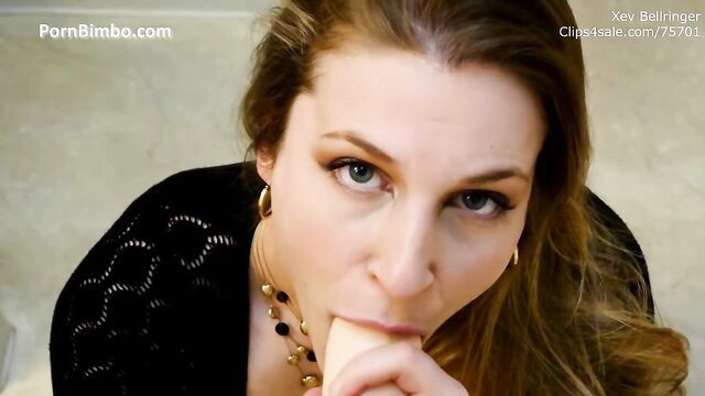 Xev Bellringer closeup sucking dildo in sexy black top