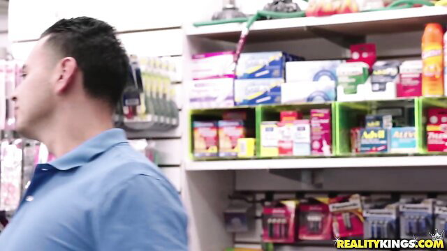 Hot guy in store aisle with Reality Kings adult video branding