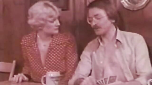 Blonde Wirtin von der Lahn in polka dot dress plays cards with man in Taboo film
