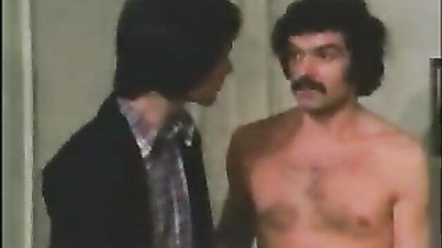 Vintage gay scene with shirtless hairy mustached man and suited guy