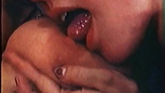 Woman licks curvy breast in hot closeup from Sylvia Sex scene