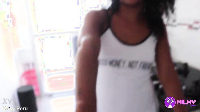 Peruvian black teen fitness model in tight tank top flexing arms