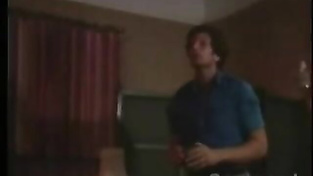 Vintage guy in blue shirt looking up in dimly lit room, Command Video