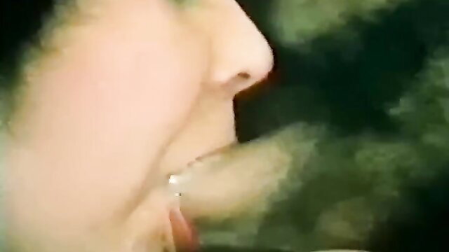 Closeup of blonde retro pornstar's face with open mouth and tongue out