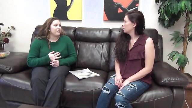Two curvy brunettes chatting on couch in teasing BBW preview