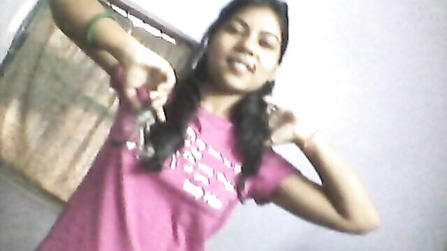 Hot Desi Indian girl in pink top with pigtails posing playfully