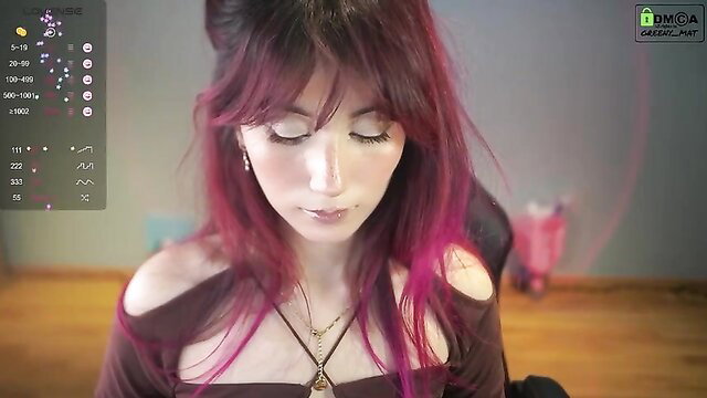Hot young goth girl with pink bangs in off-shoulder top on webcam