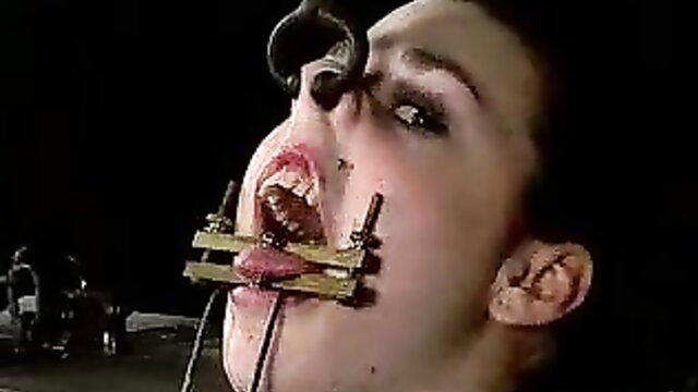 brunette slut tortured with brutal mouth clamp and tubes in BDSM hell