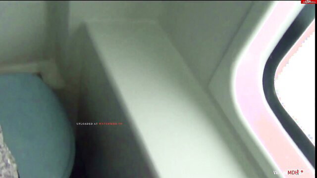 Gina Blue in train toilet with blue seat & window, teasing pose