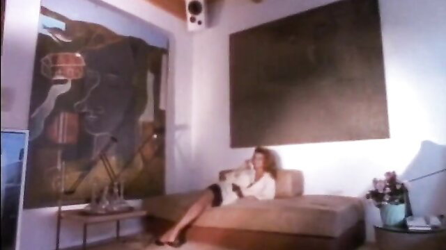 Vintage brunette babe in robe & skirt lounges seductively on couch