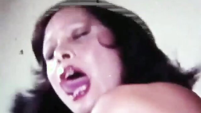 Latin lady's ecstatic face in vintage porn, big tits bouncing