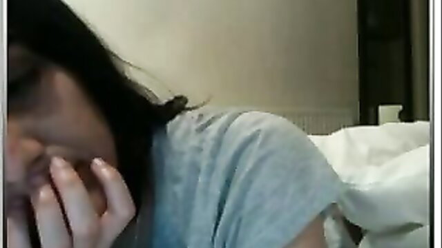 Amateur Asian babe teases with hand near mouth in webcam show