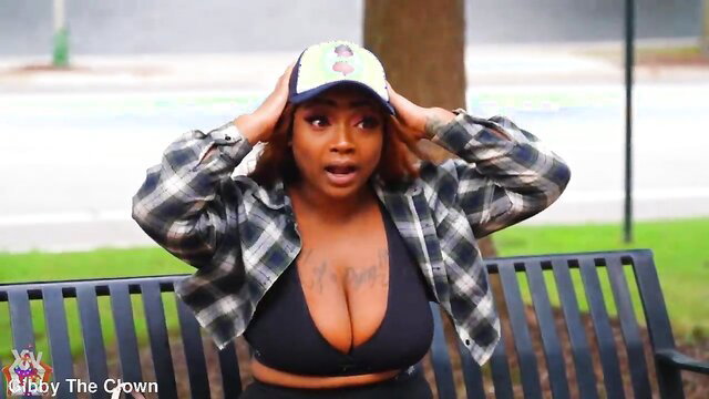 Thick ebony woman in cleavage-revealing top shocked expression park bench