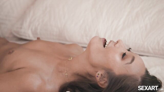 Charlotte Stokely nude on bed smiling in ecstasy, SEXART.com