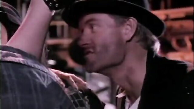 Retro hunk in hat grabs woman in Clockwork Orgy big tits orgy