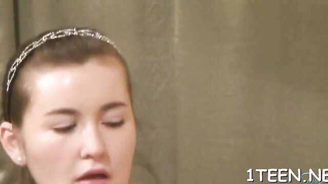 Closeup of shaved-head teen with headband in explicit oral scene