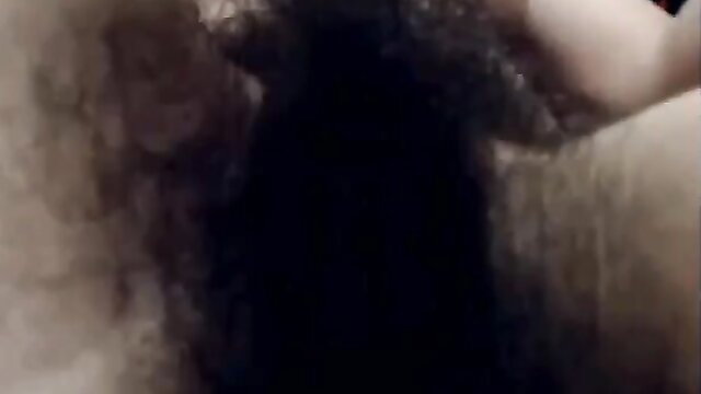 Pale hottie with bushy pussy spreads legs for camera closeup