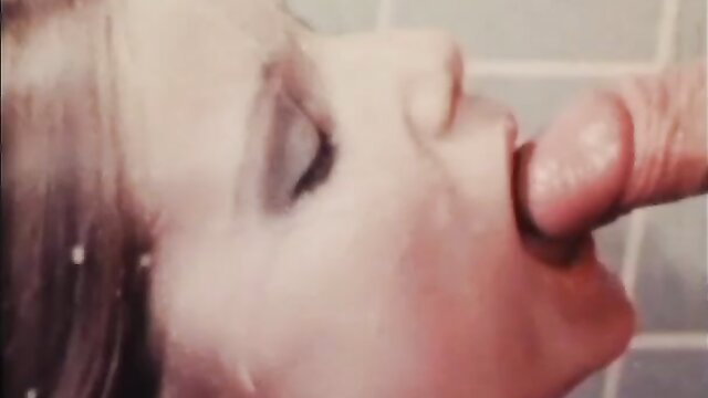 Vintage babe with 70s makeup licks cock in steamy shower closeup