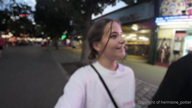 Hermione Potter smiling in public at night market, white hoodie, casual POV tease