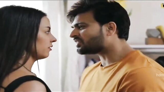 Indian couple in intense closeup face-off, her in black lingerie, him tense