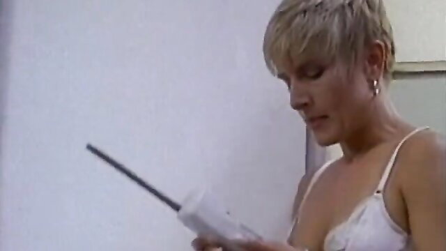 Hot short-haired blonde in lingerie holds toy, shaved pussy closeup