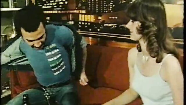 Retro interracial couple on couch, black man with brunette babe