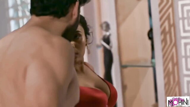 Indian busty brunette in red bra kissed by muscular man from behind
