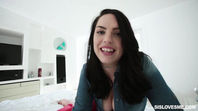 Raven Reign smiles in unbuttoned denim shirt, teasing cleavage