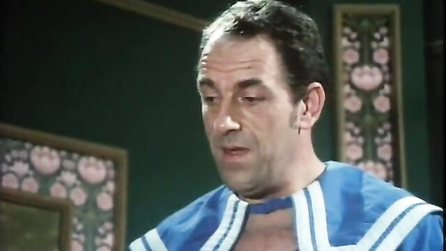 Man in open blue sailor robe exposing chest in Josefine Mutzenbacher retro scene