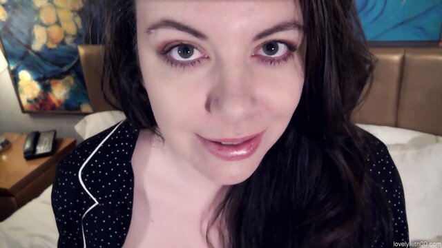 Lovely Lilith in polka dot lingerie on bed, teasing cleavage closeup