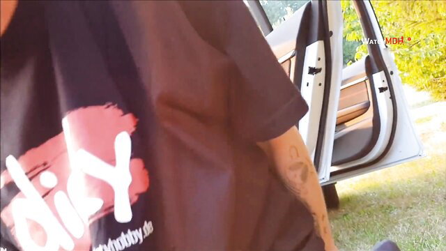 Tattooed girl in black Milfy Hobby tee deepthroats POV by white van outdoors