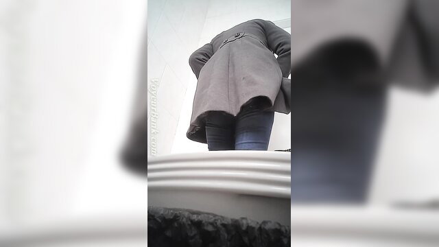 Pale white chick in trench coat bends over in toilet, hairy pussy tease