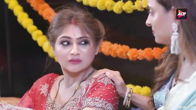 Two hot Indian women in sarees touch intimately at wedding