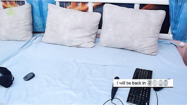 Sexy Asian cam girl on bed with keyboard, mic, headset AFK