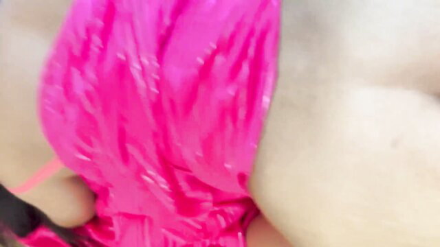 Akash Arya shiny pink dress cleavage closeup
