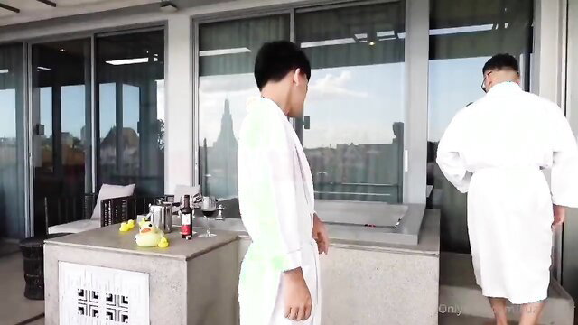 Two hot Thai boys in white robes by hot tub, gay teasing preview