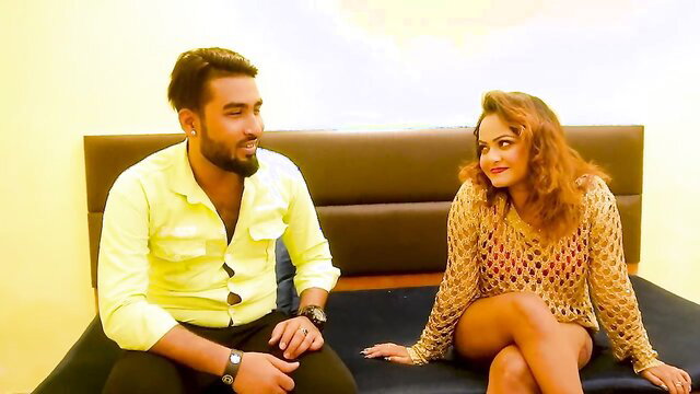 Bearded Indian guy in yellow shirt with sexy redhead tenant in netted dress on bed