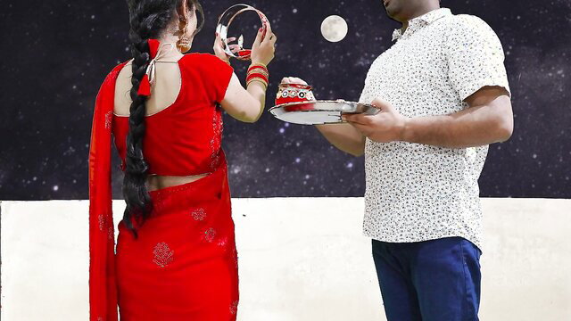 Priya in red saree holds Karva Chauth thali for husband under moonlit sky
