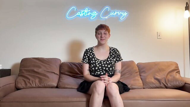 Casting Curvy redhead art hoe in polka dot top and skirt on couch