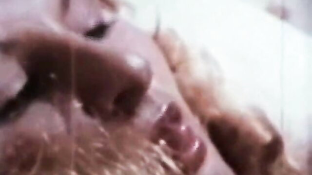 Close-up of blonde bombshell's sultry lips and nose in classic porn