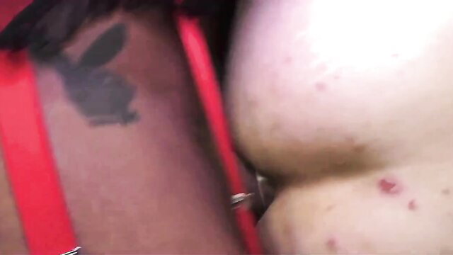 Latina with Playboy tattoo in red straps shows big pale ass closeup