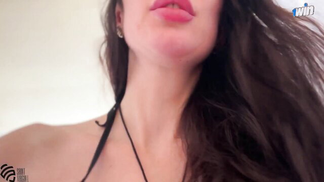 Closeup of hot brunette's plump lips and tattooed neck in steamy club tease