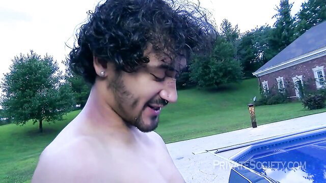 Shirtless curly-haired Latino guy smiling by pool in steamy fuck session