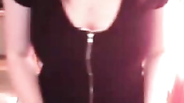 Woman in a black dress with a zipper down the front