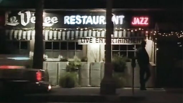 Le VeeLee Restaurant Jazz neon sign at night exterior