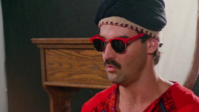 Retro hunk in red shades and turban from Peaches' wild uncensored journey