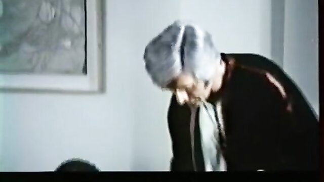 Silver-haired mature man leaning over in seductive pose