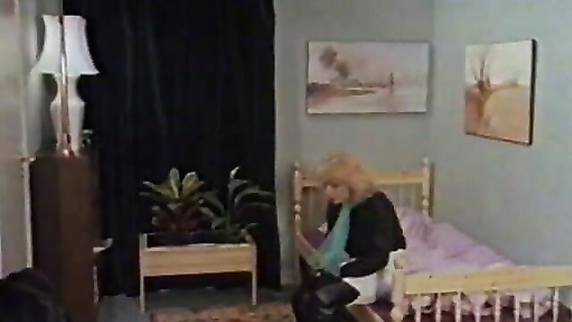 Vintage blonde in leather skirt sits on bed reading, bubble butt tease