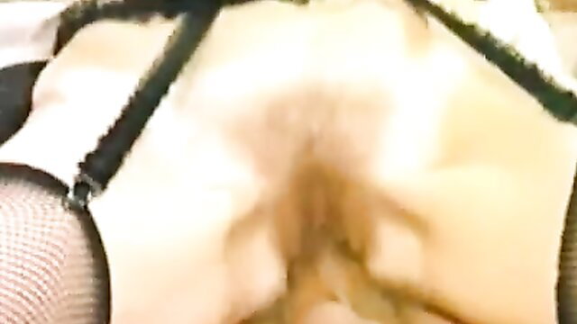 Blonde in fishnets spreads legs showing hairy pussy closeup