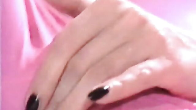 Closeup of smoking MILF's elegant hands with black nails on pink background
